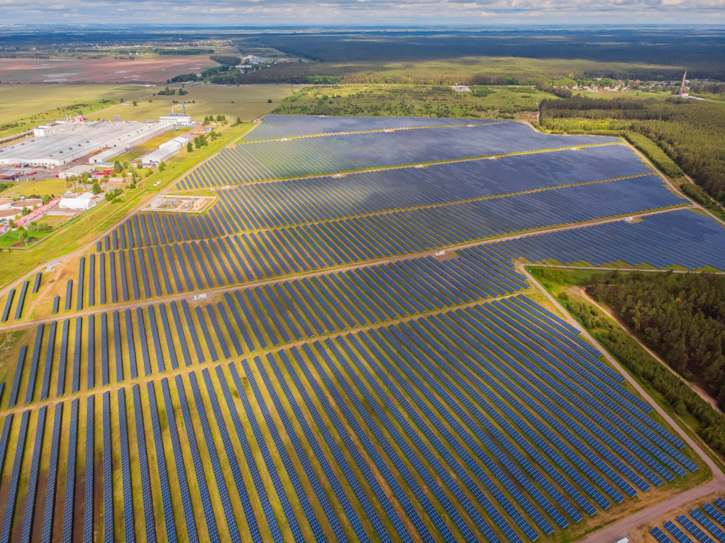 Aerial view of a large-scale solar energy installation with integrated energy storage units for improved renewable efficiency.